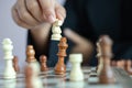 Close up shot hand of business woman playing the chess board to win by killing the king of opponent metaphor business competition