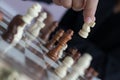 Close up shot hand of business woman playing the chess board to win by killing the king of opponent metaphor business competition