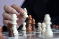 Close up shot hand of business woman playing the chess board to win by killing the king of opponent metaphor business competition