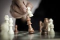 Close up shot hand of business woman playing the chess board to win by killing the king of opponent metaphor business competition