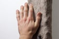 close-up shot of a hand gripping a climbing hold on an office wall Royalty Free Stock Photo