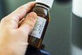 Close up shot of a hand holding a bottle with medicine with expired date. Healthcare