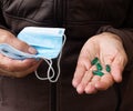 Close up shot of a hand holding several medicines