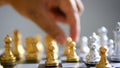 Close up shot hand of man and woman play gold and silver chess metaphor business compettition concept select focus shallow depth o