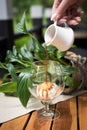 Close Up Shot Of A Hand Pouring Espresso Coffee On Vanilla Ice Cream In a Glass, Dessert, On The Rustic Wooden Table Royalty Free Stock Photo