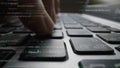 Close-Up View of a Hand Typing on a Laptop Keyboard Amidst Lines of Code and Digital Data, Symbolizing Technology and Royalty Free Stock Photo