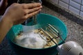 Close-up shot of a hand sifting flour into a cake batter