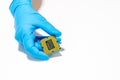 Close-up shot of a hand wearing a blue glove holding a computer processor Royalty Free Stock Photo