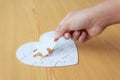 Close up shot hand of woman playing jigsaw puzzle on wooden table Royalty Free Stock Photo