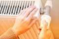 Hands Checking The Temperature Of A Heating Radiator Royalty Free Stock Photo