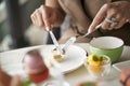 Woman eating dessert using fork and knife in restaurant