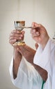 Transcendent Reverence: Priest Holding Host and Chalice in Catholic Mass Royalty Free Stock Photo