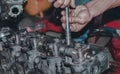 Close-up shot of hands repairing a metallic engine