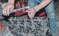 Close-up shot of hands repairing a metallic engine