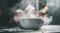Hands sifting flour into a bowl with dramatic lighting Royalty Free Stock Photo