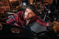 close-up shot of handsome bike repair station worker looking at motorcycle