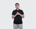 Close Up shot of handsome man wearing black polo shirt posing at plain background Royalty Free Stock Photo