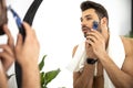 Clolse up shot of man shaving in the bathroom Royalty Free Stock Photo