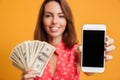 Close-up shot of happy young brunette woman holding fan of money Royalty Free Stock Photo