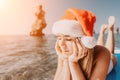 Woman sea sup. Close up portrait of happy young caucasian woman with long hair in Santa hat looking at camera and Royalty Free Stock Photo