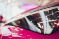 Close up shot headlight in luxury pink car background. Modern and expensive sport car concept. Royalty Free Stock Photo