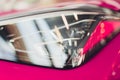 Close up shot headlight in luxury pink car background. Modern and expensive sport car concept. Royalty Free Stock Photo