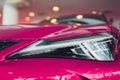 Close up shot headlight in luxury pink car background. Modern and expensive sport car concept. Royalty Free Stock Photo
