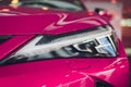 Close up shot headlight in luxury pink car background. Modern and expensive sport car concept. Royalty Free Stock Photo