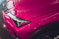 Close up shot headlight in luxury pink car background. Modern and expensive sport car concept. Royalty Free Stock Photo