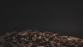 Close-up shot of a heap of coffee beans isolated on a black background Royalty Free Stock Photo