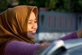 Close up shot hijab woman washing car roof with a smile Royalty Free Stock Photo