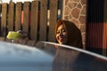 Close up shot hijab woman washing car roof with a smile Royalty Free Stock Photo