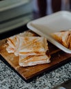 Close-up shot of hot toasted Triangle sandwiches on a wooden board Royalty Free Stock Photo