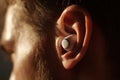 Human Ear with Wireless Earbud Technology Personal Style Royalty Free Stock Photo
