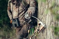 Close up shot of a hunter dressed in camouflage clothing holding a modern bow. Royalty Free Stock Photo