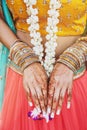 Indian bride showing menhdi henna tattoo on hand with bunch of glitter bangles on her wrist, close-up Royalty Free Stock Photo