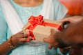 close up shot of indian girl hands receiving gift box from delivery person during diwali festive at home - concept of