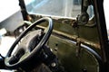 Close up shot inside an old car of the driving wheel, front glass, day light Royalty Free Stock Photo