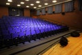 Close up shot of interior of cinema auditorium with lines of blue chairs. Horizontal shot