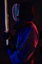 Close up shot, Kendo fighter wearing in an armor, traditional kimono, helmet practicing martial art with shinai bamboo Royalty Free Stock Photo