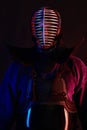 Close up shot, Kendo fighter wearing in an armor, traditional kimono, helmet practicing martial art with shinai bamboo Royalty Free Stock Photo