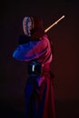 Close up shot, Kendo fighter wearing in an armor, traditional kimono, helmet practicing martial art with shinai bamboo Royalty Free Stock Photo