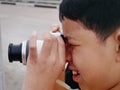 Close-up Shot of Kid Taking Photos with Mirrorless Camera