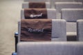 Close-up shot of a lecture hall chair with the word "RESERVED" written on the back of the chair. Royalty Free Stock Photo