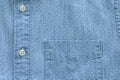 A close-up shot of a light blue shirt featuring a subtle white polka dot pattern, a chest pocket. Royalty Free Stock Photo