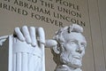 Close-up shot of the Lincoln Memorial statue with inscription in the background in Washington, DC