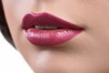 Close up shot of the lips of a woman wearing lipstick or lip glo