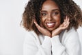 Close-up shot of lovely and tender feminine african-american girlfriend being surprised with proposal grinning of