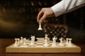 Close up shot of male hand moving chesspiece on chessboard