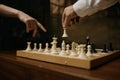 Close-up shot of male hand moving chesspiece on chessboard